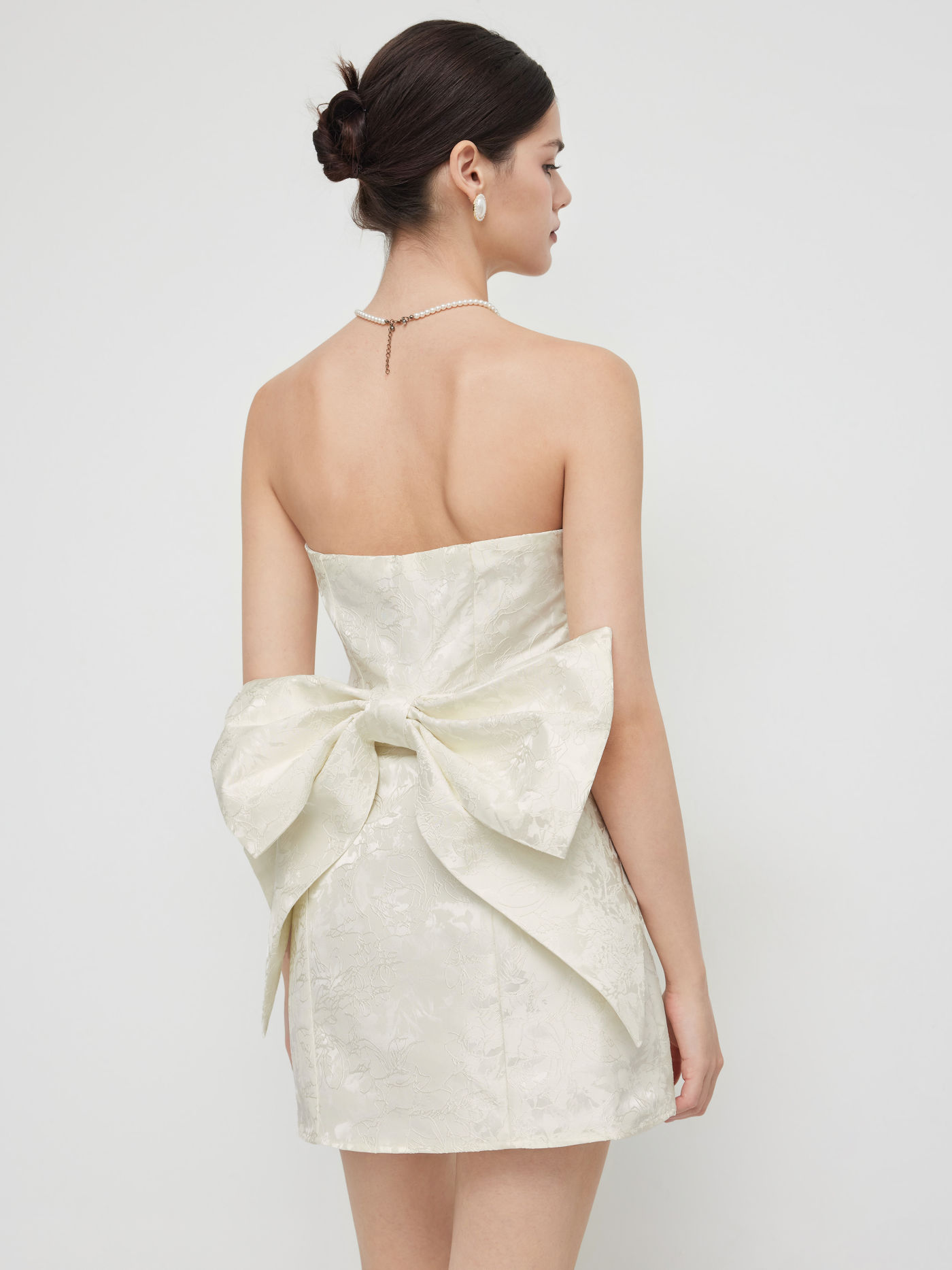 Mini abito con fiocco in tubo jacquard