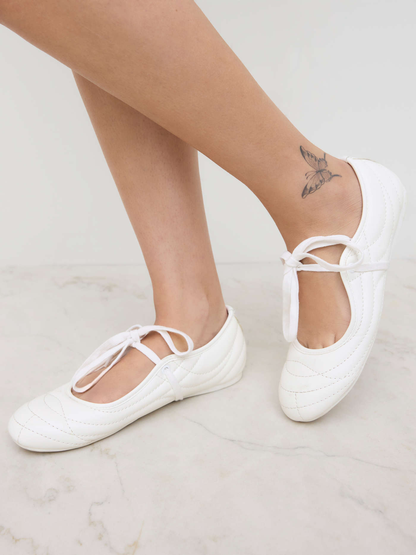 SEAM-DETAILED LACE-UP FAUX LEATHER SNEAKERS