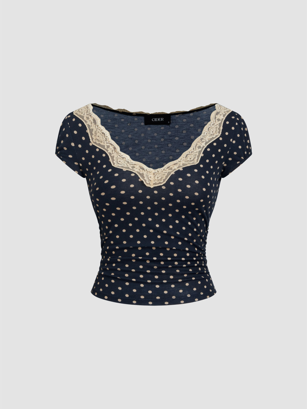 Maglietta arricciata con scollo a V, pois e finiture in pizzo