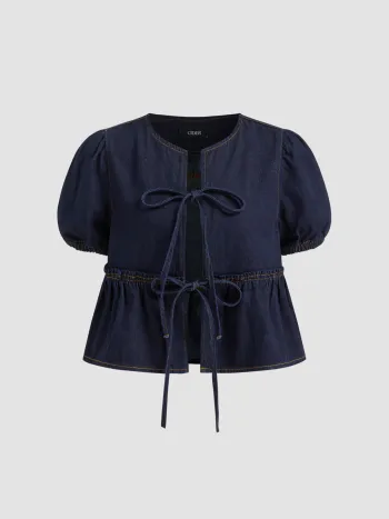 Camicetta oversize in denim con maniche a sbuffo, fiocco e nodo sul davanti