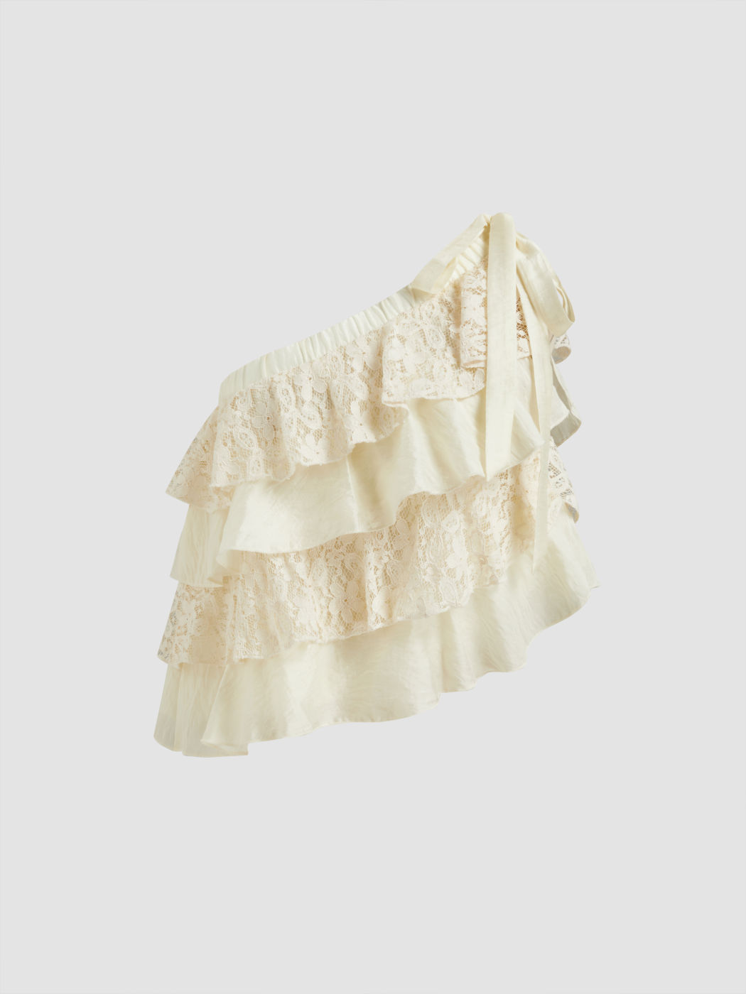 Top asimmetrico con collo in pizzo e balze a strati annodato in misto cotone