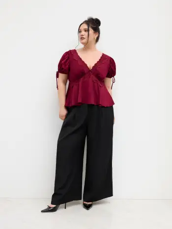 Top in raso con scollo a V, nodo, finiture in pizzo e maniche a sbuffo