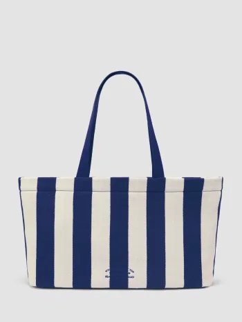 LA FRASE "WHAT HAPPENS AT THE BEACH STAYS IN THE SAND" SULLA BORSA TOTE A RIGHE