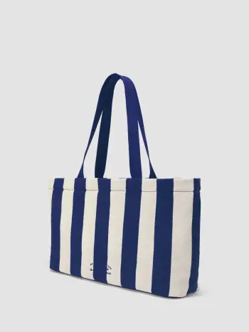 LA FRASE "WHAT HAPPENS AT THE BEACH STAYS IN THE SAND" SULLA BORSA TOTE A RIGHE