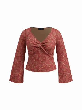 Top a maniche lunghe con scollo a V, stampa floreale e dettaglio twist, taglie comode